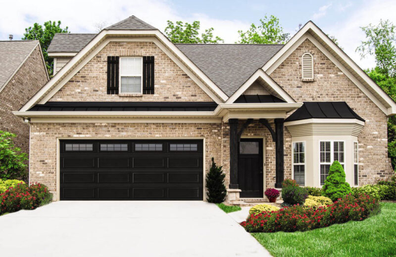 home in san antonio with a black garage door with windows on the top row