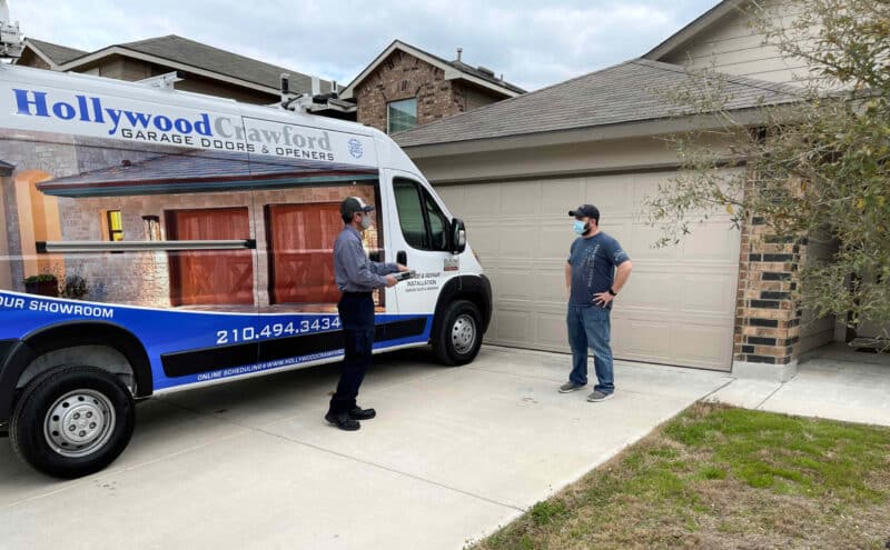 hollywood crawford talking to customer in his home driveway in front of the company van