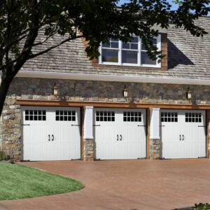 three white faux wood grain style residential garage doors on a stone home in san antonio