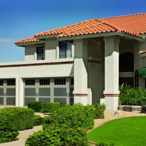 large spanish style home with three amarr classica, carriage style residential garage doors