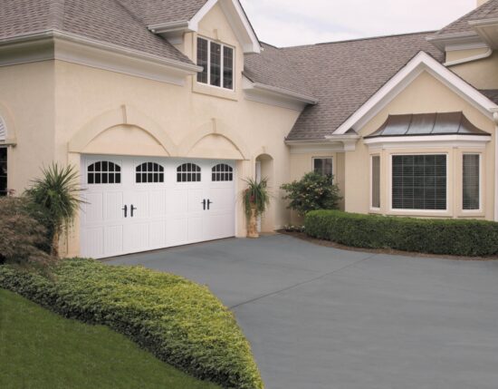 long white amarr classica, carriage style residential garage door on a cream colored home in san antonio