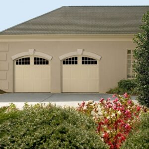san antonio home with two faux wood grain style residential garage doors