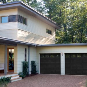 modern looking home in san antonio with two amarr heritage, faux wood grain style, short/long raised panel residential garage doors