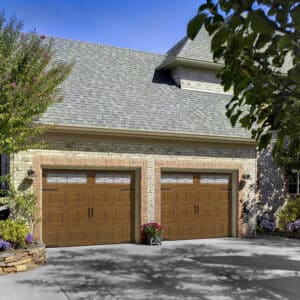 two brown carriage style, sonoma panel residential garage doors on a residential home