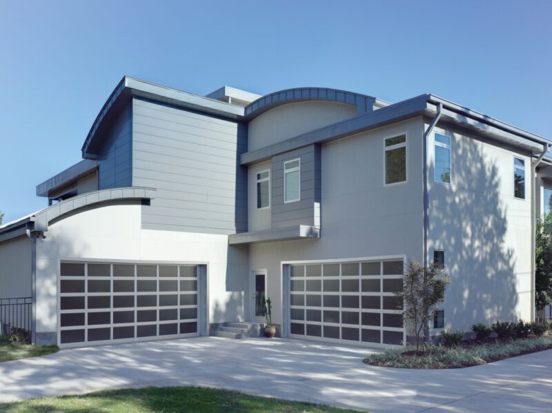 large modern grey home with two amarr vista, modern style, full view aluminum residential garage doors