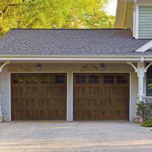 view of a home with two dark brown walnut colored clopay bridgeport, traditional style residential steel garage doors