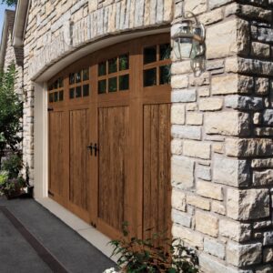 stone home in san antonio with a clopay canyon ridge, faux wood grain style residential garage door