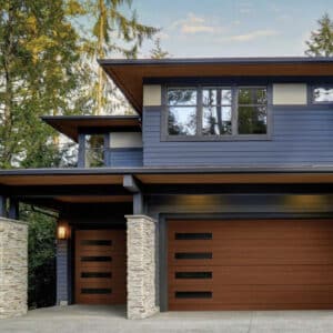 large modern home with two clopay canyon ridge, modern style residential garage doors