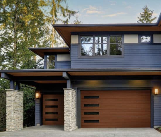 large modern home with two clopay canyon ridge, modern style residential garage doors