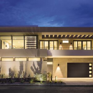 large modern home right after sunset with exterior lights shining showing a clopay canyon ridge, modern style residential garage door