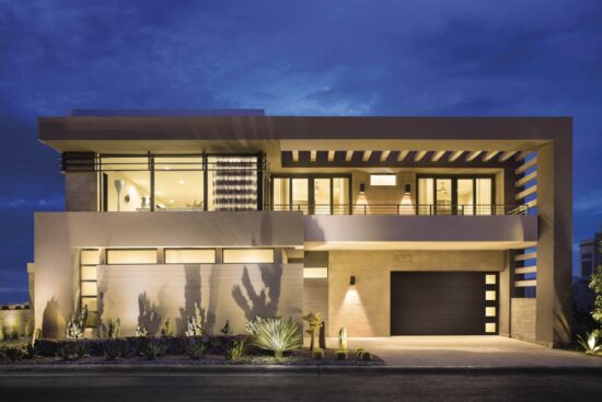 large modern home right after sunset with exterior lights shining showing a clopay canyon ridge, modern style residential garage door