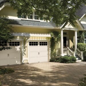 home with two white long SQgrilles clopay gallery, faux wood grain style, residential garage door with windows on the top row