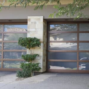 closeup of a modern home with two martin elite athena, modern style, full-view aluminum residential garage doors