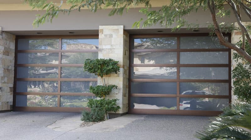 closeup of a modern home with two martin elite athena, modern style, full-view aluminum residential garage doors