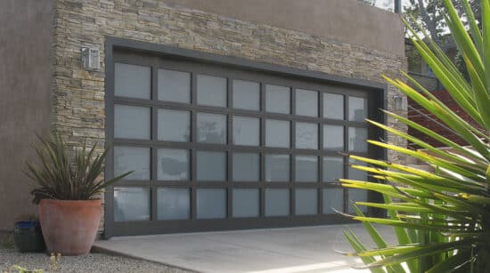 home with a martin elite athena, modern style, full-view aluminum residential garage door and plants by the door