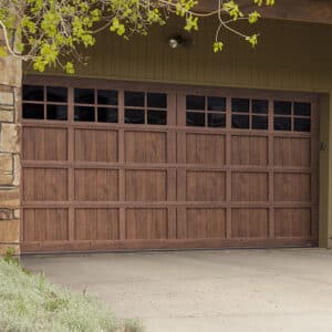 closeup of a san antonio home with a martin elite pinnacle, faux wood grain style, V/H-groove residential garage door