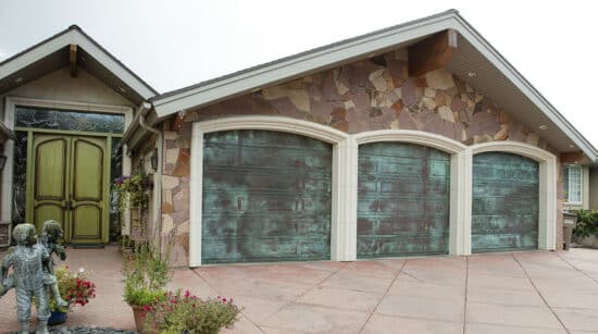 intersting home with green front door and three martin elite copper, modern style residential garage doors with a teal wash to them