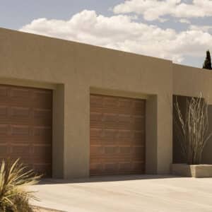 two martin elite copper, modern style residential garage doors on a clay style home