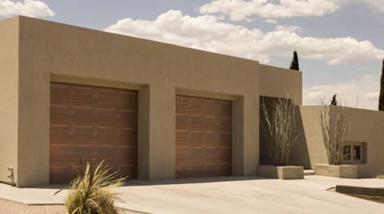two martin elite copper, modern style residential garage doors on a clay style home