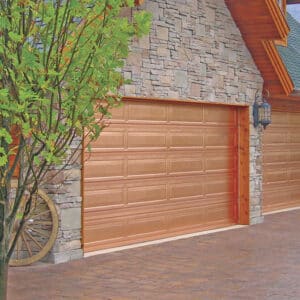 closeup of two martin elite copper, modern style residential garage doors on a stone home in san antonio