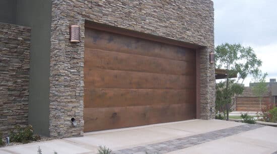 closeup of a martin elite copper, modern style residential garage door on a tiled home in san antonio