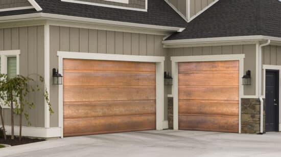closeup of a home in san antonio with two martin elite copper, modern style residential garage doors