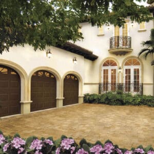 spanish style home in san antonio with three clopay premium classic series, traditional style residential garage doors