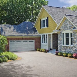 a partially red brick home with a clopay premium classic series, traditional style residential garage door