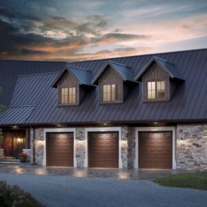 large home at dusk with three dark brown clopay premium classic series, faux wood style residential garage doors