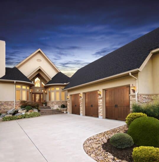 home in san antonio with three clopay canyon ridge, faux wood grain style residential garage doors