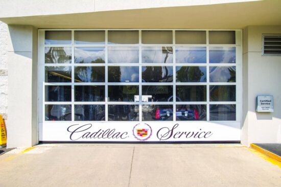 large commercial aluminum full-view door on a cadillac service shop