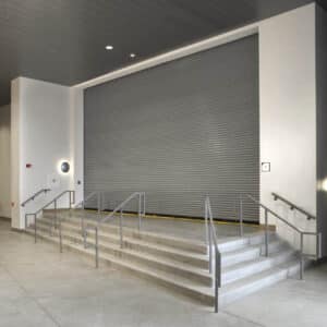 large commercial rolling fire garage door on top of steps in a commercial building