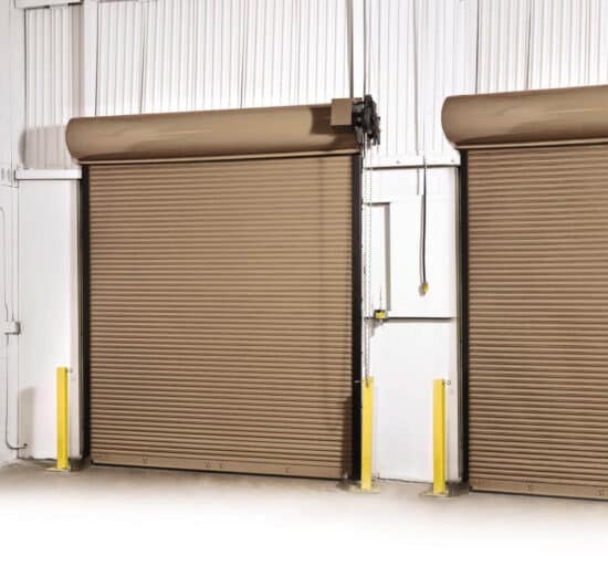 two brown commercial rolling fire garage door side by side in a warehouse setting