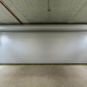 wide commercial rolling garage door in a parking garage