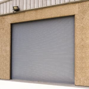large commercial rolling door on the exterior of a warehouse setting