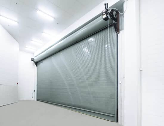 large commercial rolling door on the interior of a warehouse setting