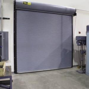 grey commercial rolling door on the exterior of a commercial warehouse building