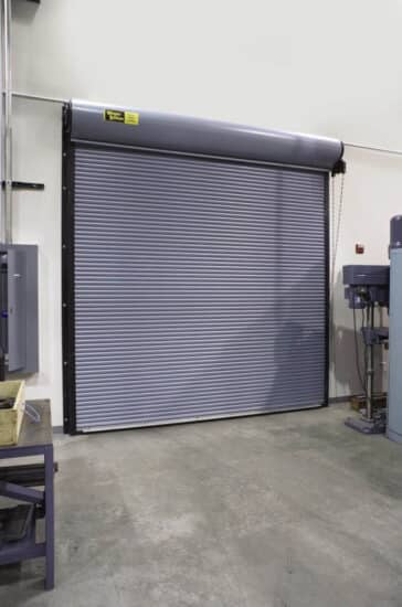 grey commercial rolling door on the exterior of a commercial warehouse building