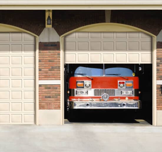 garage door opening on a firehouse as a fire truck begins to drive out