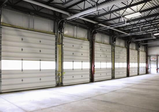 multiple commercial garage doors in a warehouse building
