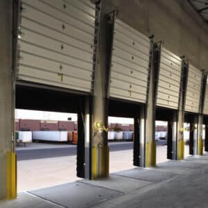 multiple commercial garage doors in a warehouse building