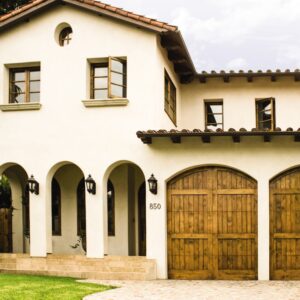 large residential home with two custom wood garage doors in san antonio