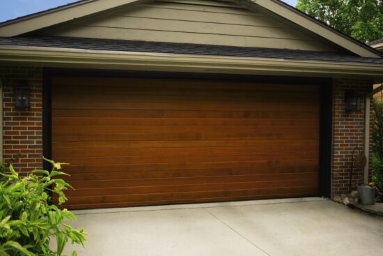 large custom wood residential garage door on san antonio home