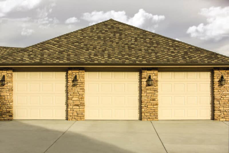 three traditional style, colonial/ranch raised panel garage doors on a residential home