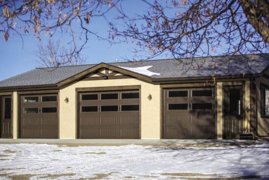 residential home with multiple faux wood grain style, sonoma/sonoma ranch panel garage doors