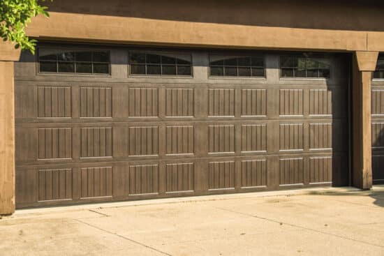 residential home with a faux wood grain style, sonoma/sonoma ranch panel garage door