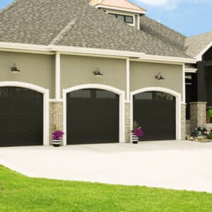 residential home with three faux wood grain style, sonoma/sonoma ranch panel garage doors