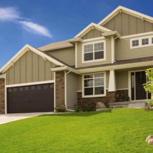 residential home with two faux wood grain style, sonoma/sonoma ranch panel garage doors