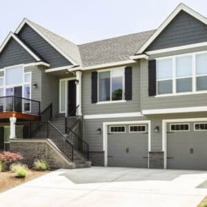 large dark grey home in san antonio with two carriage style, sonoma/sonoma ranch panel residential garage doors
