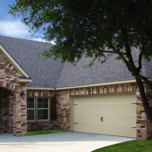dark colored brick home in san antonio with a cream colored carriage style, sonoma/sonoma ranch panel residential garage door
